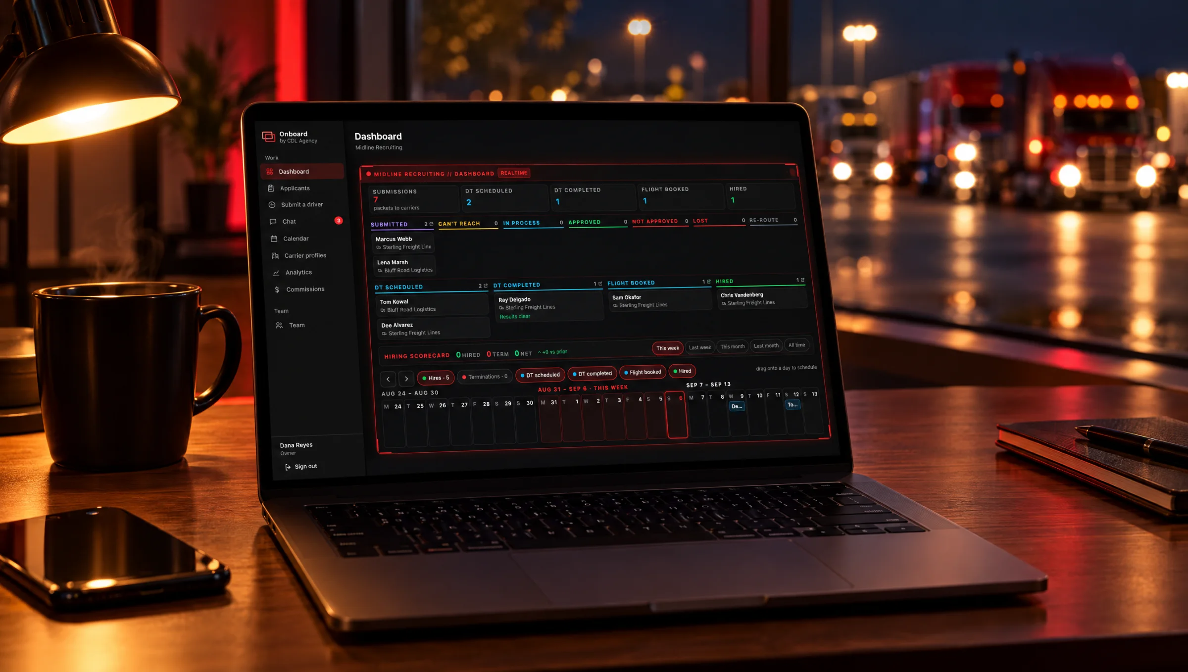 Onboard's recruiter dashboard on a laptop in a trucking office at night