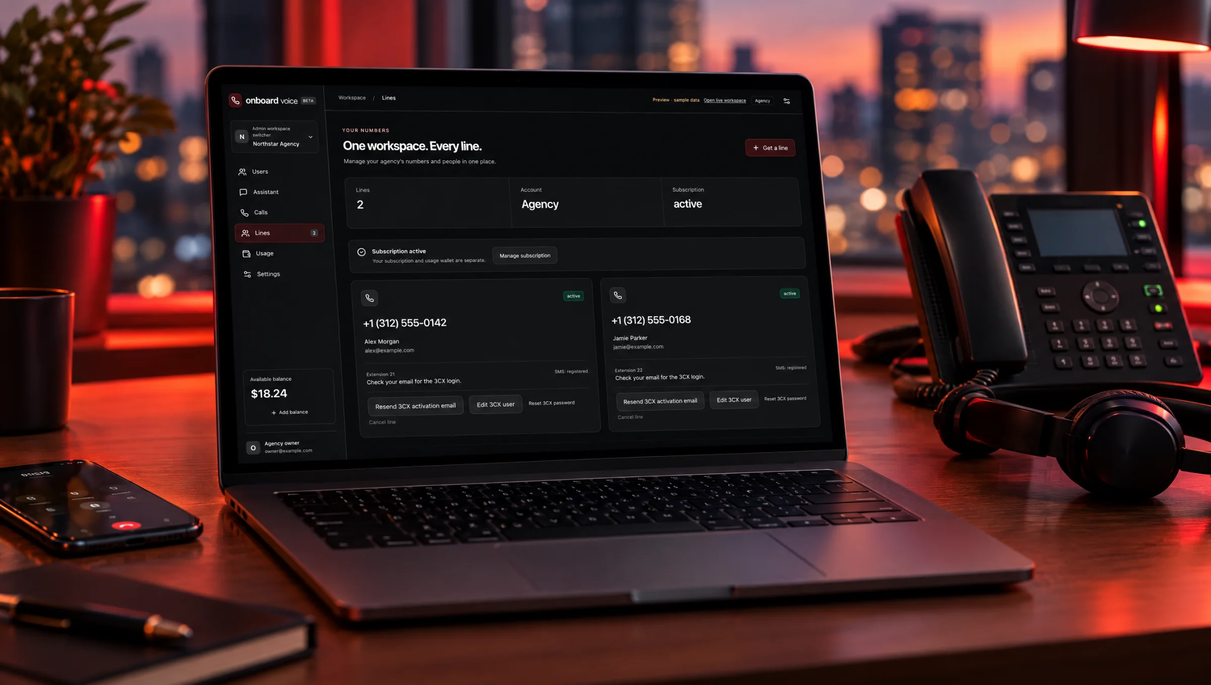 Onboard Voice lines dashboard on a laptop beside a desk phone