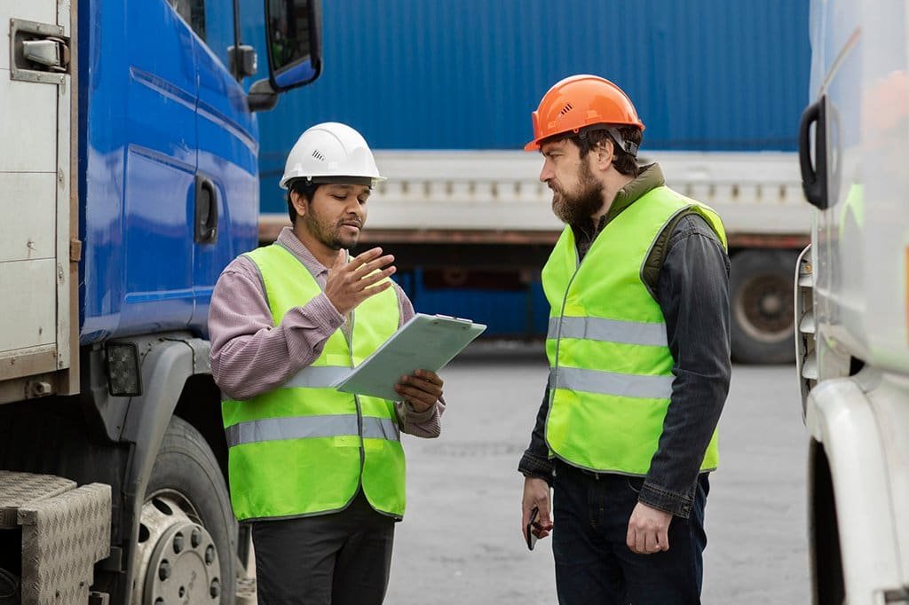 a group of men wearing safety vests and helmets