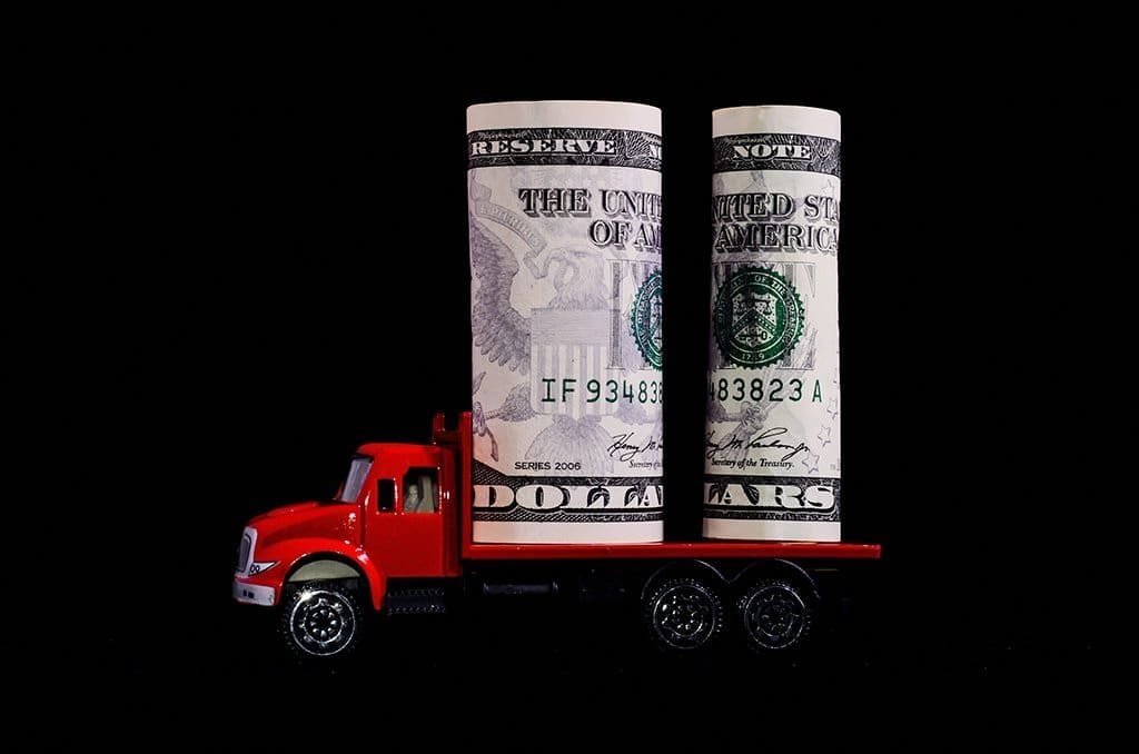 a toy truck carrying money