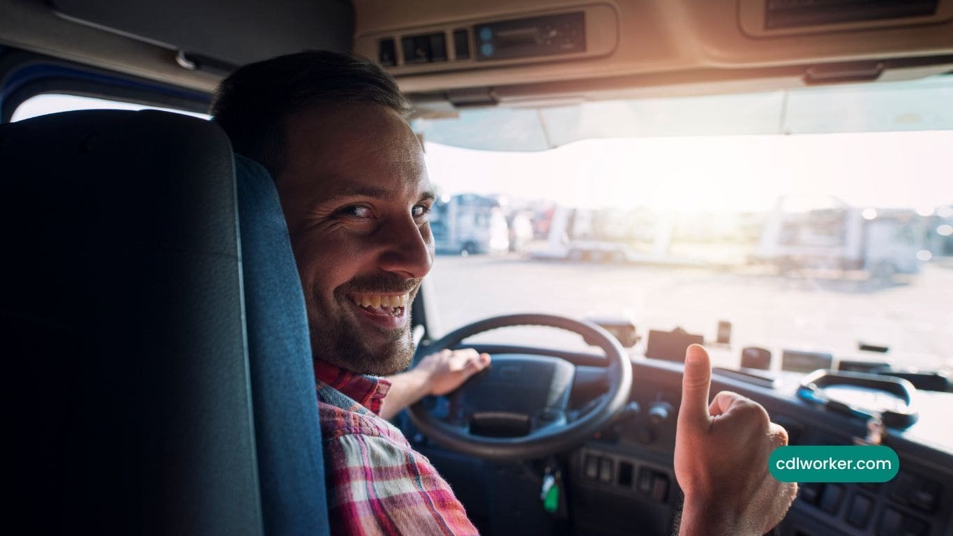 cdl driver behind the wheel showing thumbs up