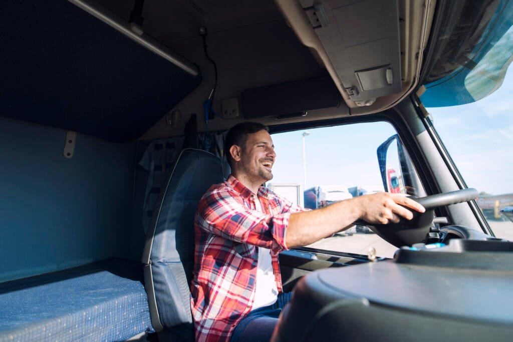 truck driver smiling behind the wheel